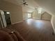 View of a large attic bedroom with a bathroom, ceiling fans and natural light at 1119 Plantation Se Dr, Conyers, GA 30094