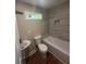 Bathroom featuring a sink, toilet, tub, and a window for natural light at 1119 Plantation Se Dr, Conyers, GA 30094