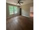 This airy bedroom is complemented by a ceiling fan and scenic backyard views at 1119 Plantation Se Dr, Conyers, GA 30094