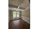 Elegant dining room with tray ceiling, wainscoting, and abundant natural light at 1119 Plantation Se Dr, Conyers, GA 30094
