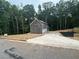Long driveway leading to a new two-story home with an attached garage and freshly landscaped surroundings at 1119 Plantation Se Dr, Conyers, GA 30094