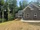 Beautiful new two-story home showcasing stone details and a manicured front yard at 1119 Plantation Se Dr, Conyers, GA 30094