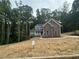 Stunning two-story home with a mix of stone and siding, a cozy front porch, and a professionally landscaped yard at 1119 Plantation Se Dr, Conyers, GA 30094