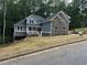 Charming new two-story home featuring stone accents, a welcoming front porch, and professional landscaping at 1119 Plantation Se Dr, Conyers, GA 30094