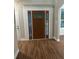 Inviting front door with decorative glass sidelights and transom window at 1119 Plantation Se Dr, Conyers, GA 30094