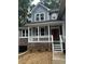 Charming front entrance featuring a covered porch, wood door with glass, and manicured landscaping at 1119 Plantation Se Dr, Conyers, GA 30094