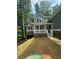 Inviting two-story home with a covered front porch, stone accents, and a freshly landscaped yard at 1119 Plantation Se Dr, Conyers, GA 30094
