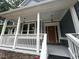 Close up of the front porch showcasing decorative trim, new siding, and craftsman style lighting at 1119 Plantation Se Dr, Conyers, GA 30094