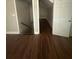 Hallway with wood floors and a door leading to additional rooms in the home at 1119 Plantation Se Dr, Conyers, GA 30094