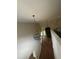 Hallway with an elegant light fixture offering views into a naturally lit room at 1119 Plantation Se Dr, Conyers, GA 30094