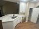 The kitchen boasts a sink, white cabinets, stainless steel appliances, and a modern design at 1119 Plantation Se Dr, Conyers, GA 30094