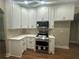 This kitchen showcases white cabinets, granite countertops, and stainless steel appliances at 1119 Plantation Se Dr, Conyers, GA 30094
