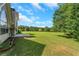 Beautiful backyard with an expansive lawn and view of the surrounding landscape at 164 Gleneagles Way, Fayetteville, GA 30215
