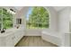 Bright and airy bathroom with double sinks, a garden tub, and a large arched window at 164 Gleneagles Way, Fayetteville, GA 30215