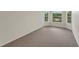 Clean and simple bedroom with neutral carpet and bright natural lighting from the windows at 164 Gleneagles Way, Fayetteville, GA 30215