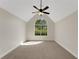 Spacious bedroom featuring a vaulted ceiling, neutral carpet, and a large arched window at 164 Gleneagles Way, Fayetteville, GA 30215