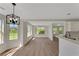 Bright dining room featuring stylish floors, many windows and modern lighting fixtures at 164 Gleneagles Way, Fayetteville, GA 30215