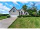 Charming home featuring a manicured lawn, double-door entrance, and an attached two-car garage at 164 Gleneagles Way, Fayetteville, GA 30215