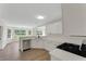 Well-lit kitchen featuring white cabinets, countertops, and stainless steel appliances at 164 Gleneagles Way, Fayetteville, GA 30215