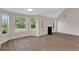 Bright, airy living room with high ceilings, fireplace, and stylish flooring at 164 Gleneagles Way, Fayetteville, GA 30215