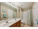 Bathroom featuring a double sink vanity, neutral tile floor, and tub with shower at 245 Amal Sw Dr # 2018, Atlanta, GA 30315
