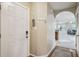 Inviting entryway with white door, coat hooks, and archway leading to the living area, showcasing a welcoming ambiance at 245 Amal Sw Dr # 2018, Atlanta, GA 30315