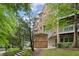 Brick apartment building showcasing an inviting exterior with well-manicured lawns and trees at 245 Amal Sw Dr # 2018, Atlanta, GA 30315