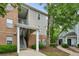 Apartment complex featuring brick and siding exterior with multiple units and stairway access, nestled among mature trees at 245 Amal Sw Dr # 2018, Atlanta, GA 30315