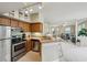 Kitchen flows into a open-concept living space, featuring stainless steel appliances and wood cabinets at 245 Amal Sw Dr # 2018, Atlanta, GA 30315