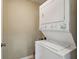 Efficient laundry room with stacked washer and dryer for space-saving convenience at 245 Amal Sw Dr # 2018, Atlanta, GA 30315