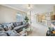 Spacious living room with a comfortable gray sofa, glass coffee table, and open layout leading to the kitchen area at 245 Amal Sw Dr # 2018, Atlanta, GA 30315