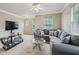 Inviting living room boasts a gray sectional, glass coffee table, and a media center, creating a relaxing atmosphere at 245 Amal Sw Dr # 2018, Atlanta, GA 30315