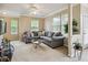 Cozy living room featuring a comfortable gray sectional sofa, plush carpeting, and ample natural light from large windows at 245 Amal Sw Dr # 2018, Atlanta, GA 30315