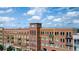 A multi-story building featuring brick facade and private balconies on a sunny day at 360 Chambers St # 405, Woodstock, GA 30188