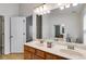 Bathroom featuring an updated vanity with double sinks, a large mirror and modern lighting at 4490 Epworth Court Ct, Powder Springs, GA 30127