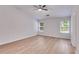 Spacious bedroom featuring lots of natural light, neutral walls, and light hardwood floors at 4490 Epworth Court Ct, Powder Springs, GA 30127