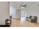 Spacious living area with hardwood floors, featuring a modern ceiling fan and ample room for seating at 4490 Epworth Court Ct, Powder Springs, GA 30127