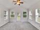 Cozy sunroom filled with natural light from many windows, offering a tranquil retreat with easy access to the outdoors at 4490 Epworth Court Ct, Powder Springs, GA 30127