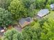Aerial view of an inviting single-Gathering home with a paved driveway and lush green surroundings at 48 Saddle Field Nw Cir, Cartersville, GA 30121