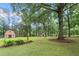 Expansive backyard featuring lush greenery and two sheds offering ample storage at 48 Saddle Field Nw Cir, Cartersville, GA 30121