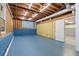 Spacious unfinished basement with exposed ceiling and blue painted floors at 48 Saddle Field Nw Cir, Cartersville, GA 30121