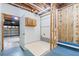 Partially finished basement with garage access, wood cabinetry, and concrete foundation at 48 Saddle Field Nw Cir, Cartersville, GA 30121