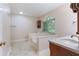 Bright bathroom features a soaking tub, window with lush green views, and a sleek countertop with sink at 48 Saddle Field Nw Cir, Cartersville, GA 30121