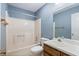 Bathroom features a tub/shower combination, vanity with sink, and classic blue wallpaper at 48 Saddle Field Nw Cir, Cartersville, GA 30121