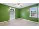 Cozy bedroom with green walls, neutral carpet, and window with wooded outdoor views at 48 Saddle Field Nw Cir, Cartersville, GA 30121