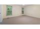 Neutral bedroom with carpet and two large windows bringing in natural light and views of the lush outdoors at 48 Saddle Field Nw Cir, Cartersville, GA 30121