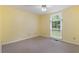 Bright bedroom with yellow walls, ceiling fan, neutral carpet, and window overlooking the lush backyard at 48 Saddle Field Nw Cir, Cartersville, GA 30121