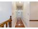 Long hallway with hardwood floors, trim and neutral wall color, creating a bright and spacious transition at 48 Saddle Field Nw Cir, Cartersville, GA 30121