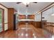 Open kitchen with hardwood flooring, stainless steel appliances, and seamless flow to adjacent living spaces at 48 Saddle Field Nw Cir, Cartersville, GA 30121