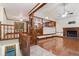 Bright living room with hardwood floors, a brick fireplace, and a partial view of the kitchen at 48 Saddle Field Nw Cir, Cartersville, GA 30121